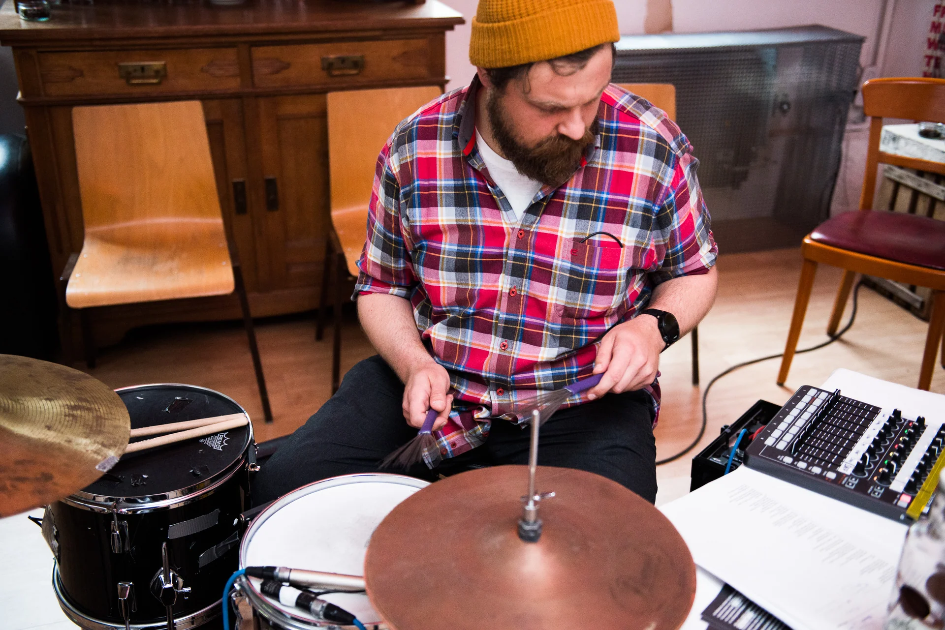 Markus Zink playing a drum kit with brushes beside an electronic controller