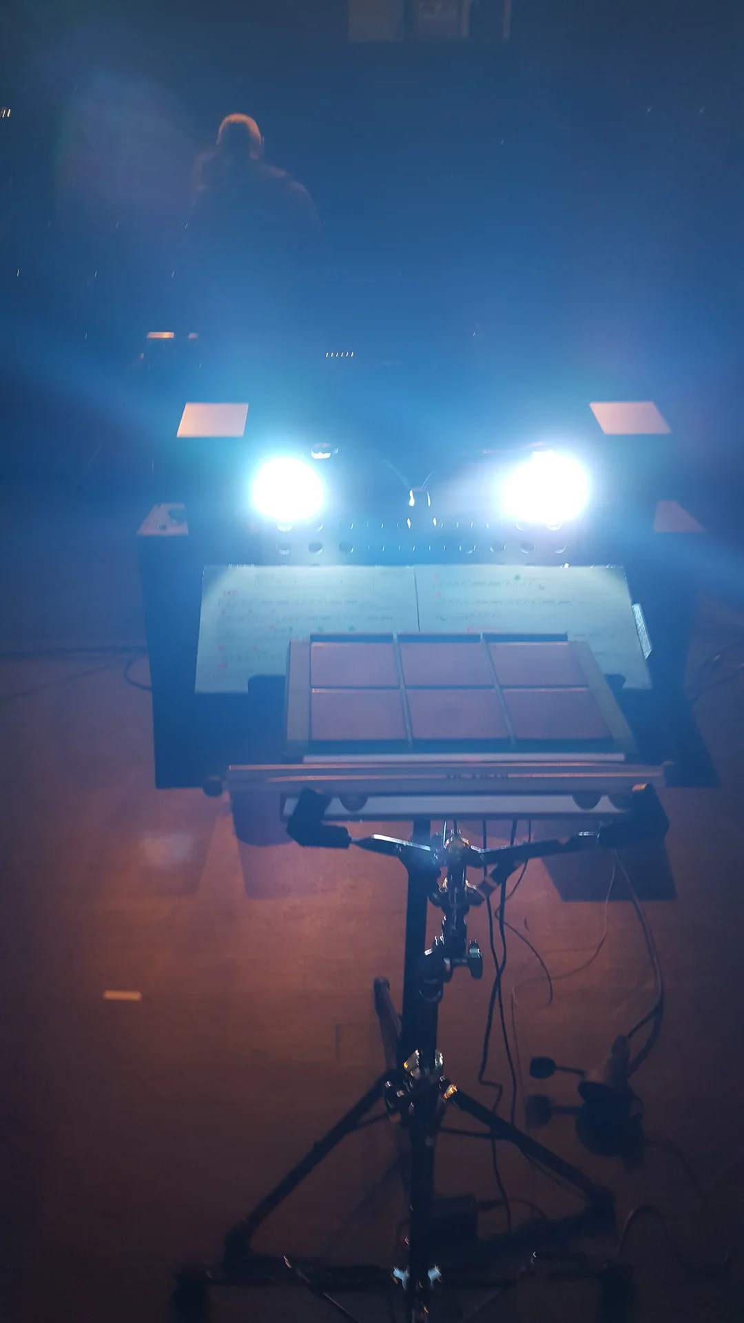Electronic percussion pads, a score and two lights on a stand