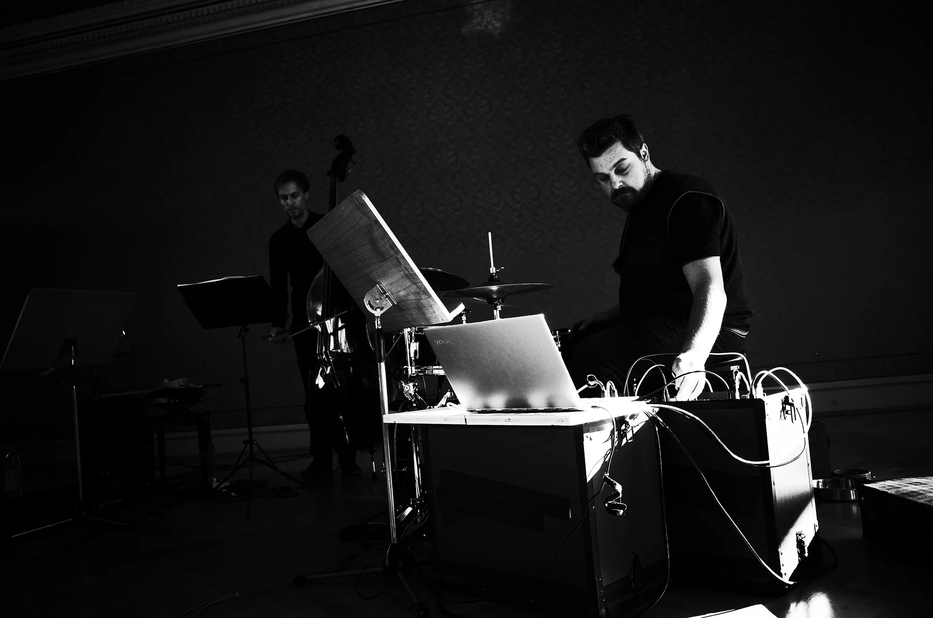 Markus Zink at a laptop and electronics with a double-bass player behind him