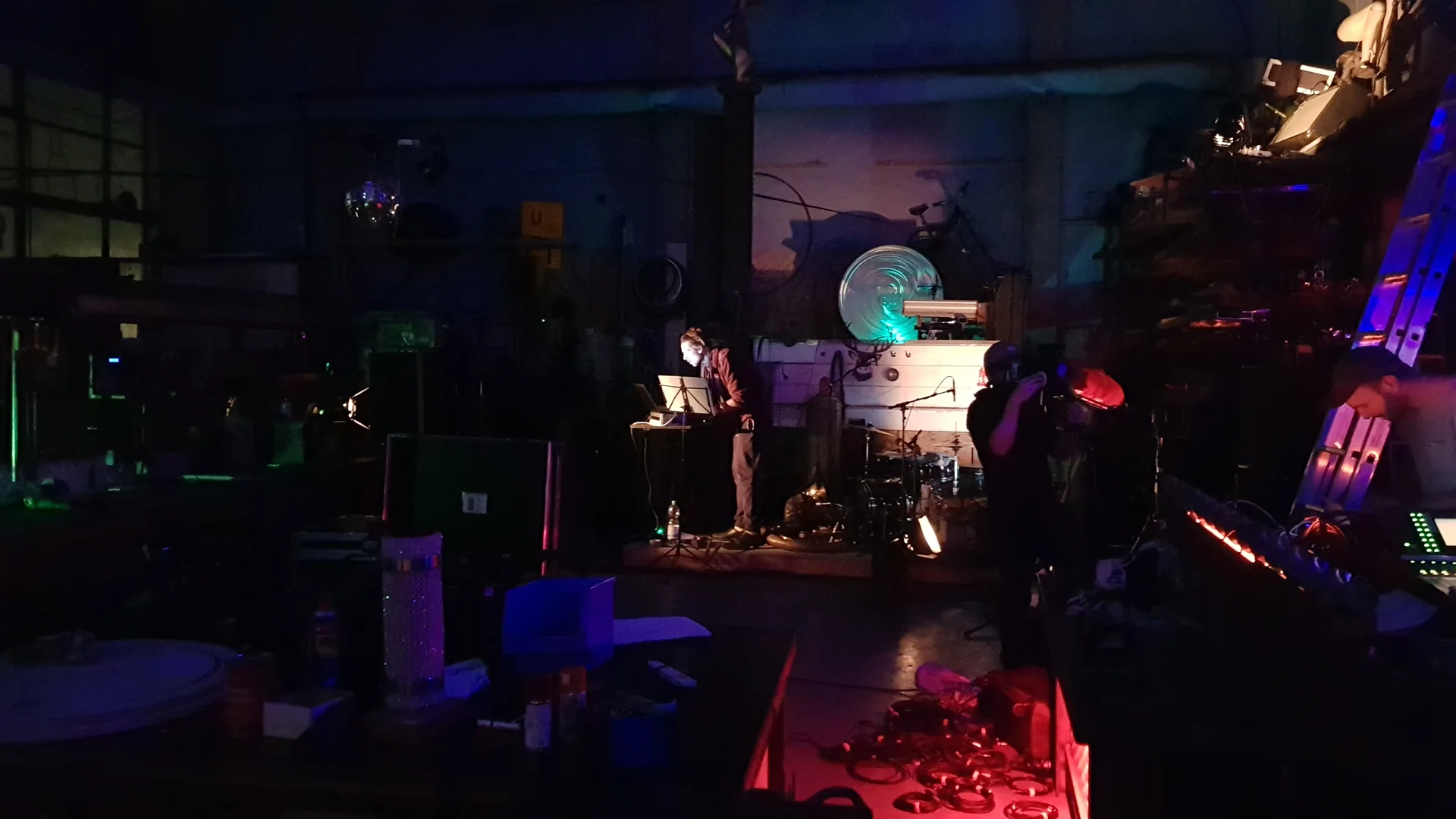 Musicians performing with acoustic instruments and electronics in an industrial space